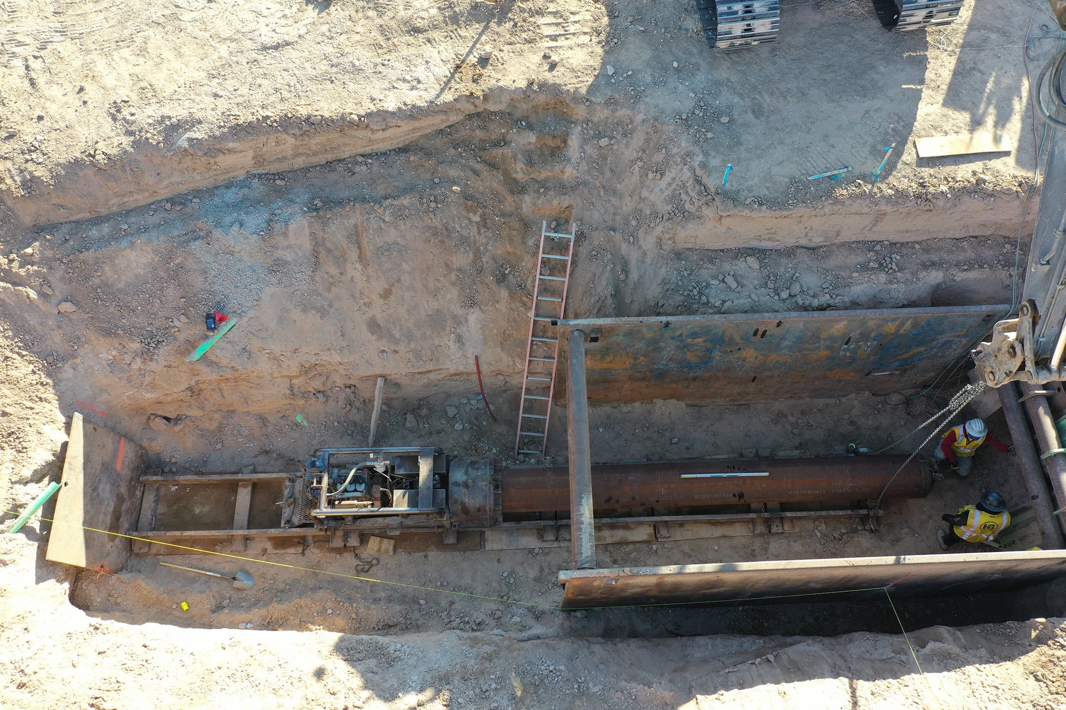 Auger boring and large-diameter pipe installation in a shored pit